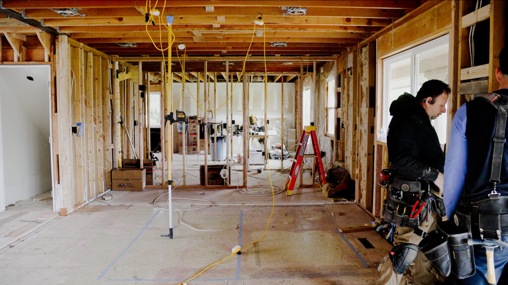 Before photo of a home remodeling project showing open walls ready for new electrical wiring.
